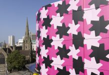 Selfridges transforms the outside of its iconic Birmingham store to showcase a new black and pink patterned design titled Infinity Pattern 1.