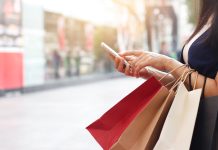 shopping bags and smartphone as online sales sees consumer spend up