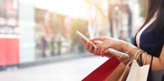 shopping bags and smartphone as online sales sees consumer spend up
