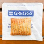 Greggs pasty on branded paper bag