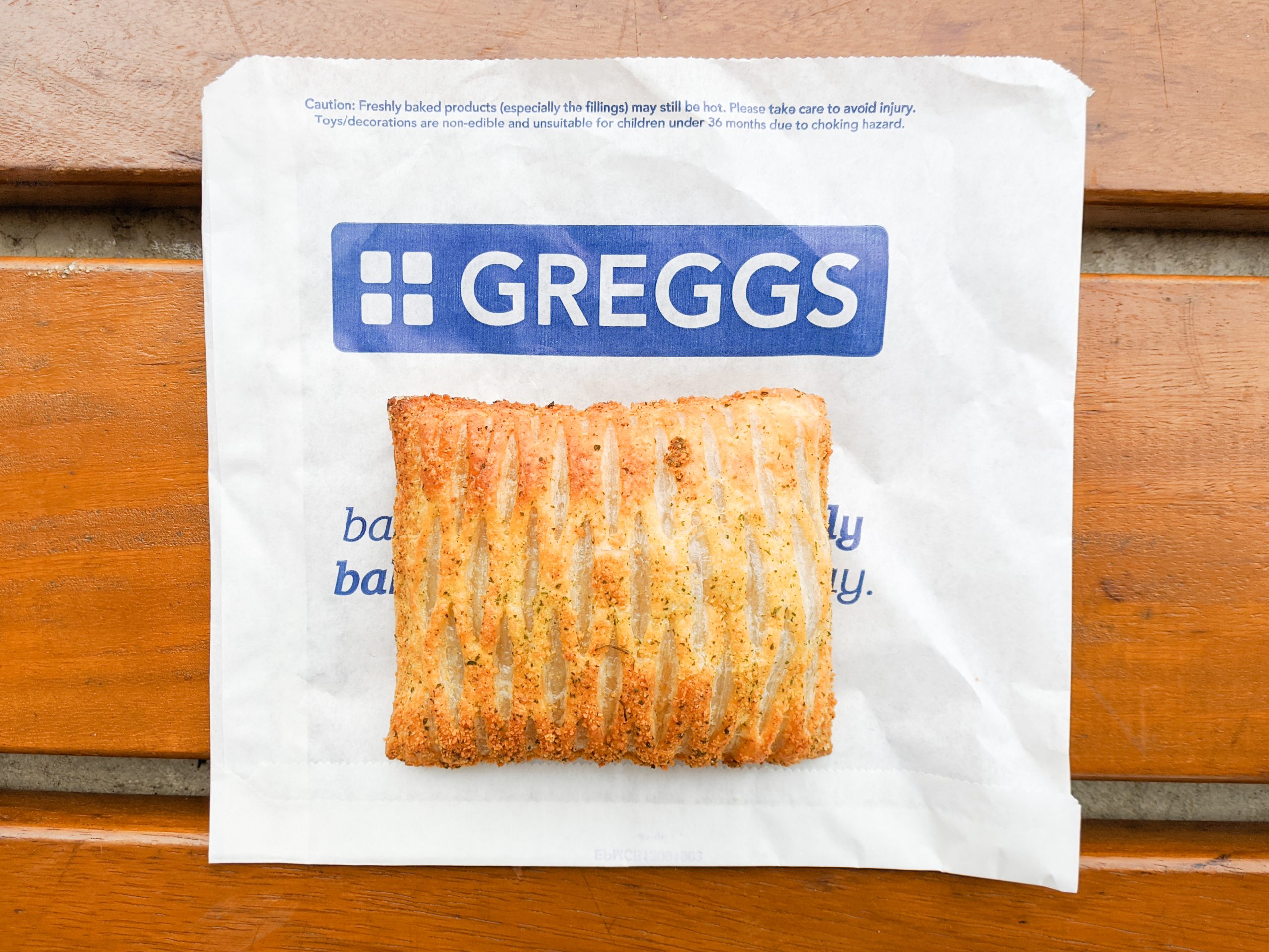 Greggs pasty on branded paper bag