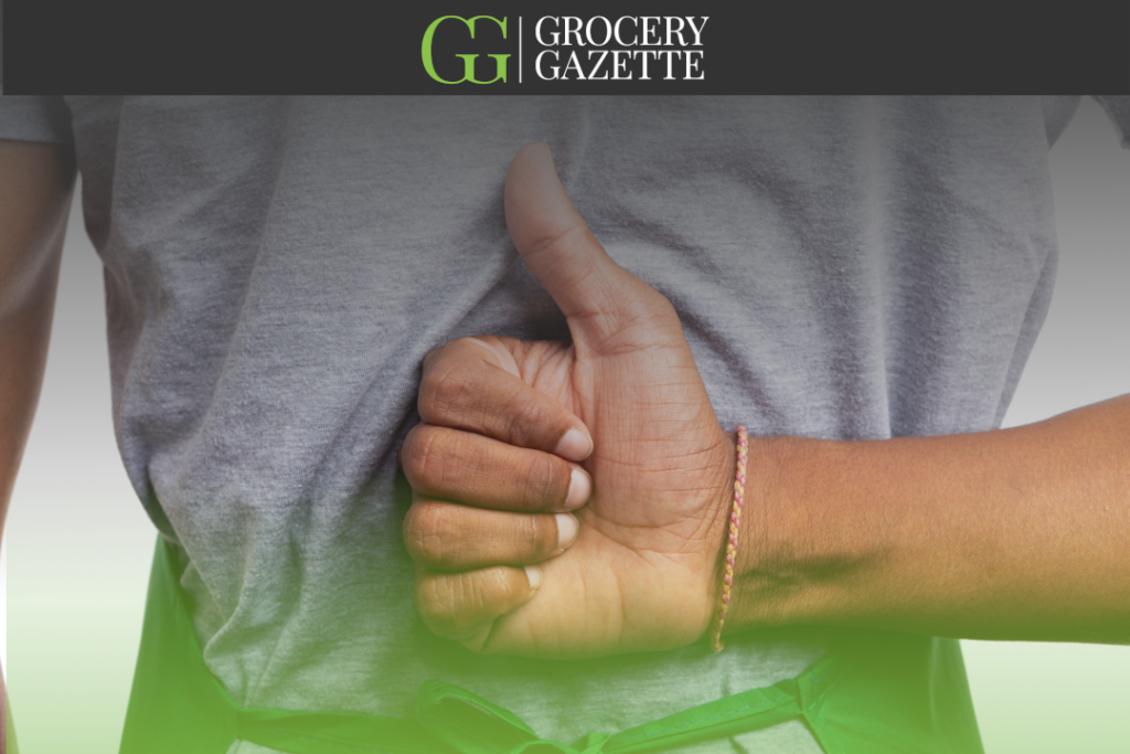 Employee holding a thumbs up behind their back