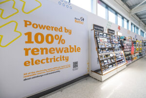 Wall at a Sainsbury's store that says "powered by 100% renewable enery"