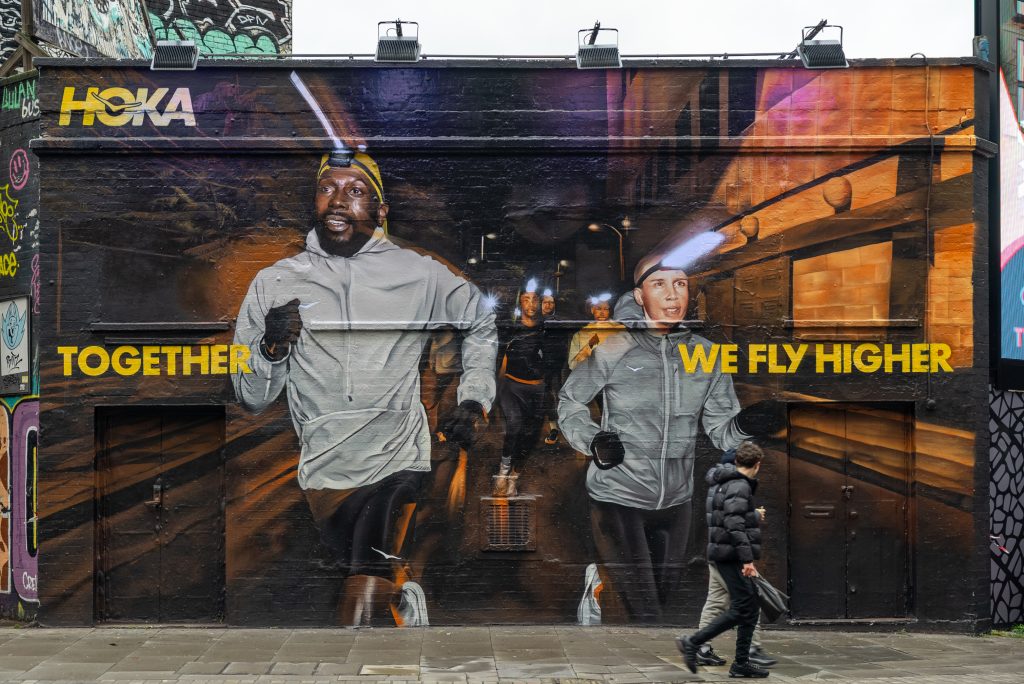 Shoe brand and retailer Hoka has unveiled a bold UV-responsive mural in Shoreditch, London.